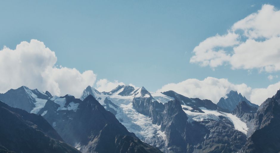 Stunning snowy mountain peaks against a clear blue sky, perfect for nature lovers.